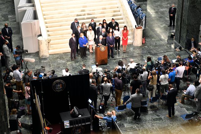 The Assembly Judiciary Committee members stand with Carl Heastie in the capitol building - aerial photo showing the members plus members of the media